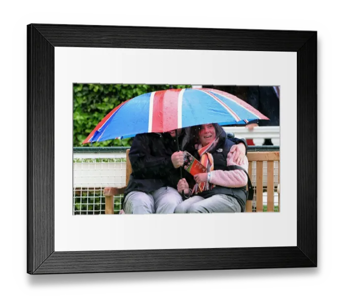 Framed Print : Taking Shelter From Rain Under Union Jack Umbrella