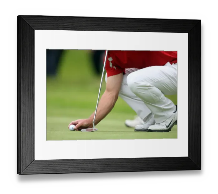 Framed Print : Golfer Replaces Ball On Green Framed Print : Golfer Replaces Ball On Green