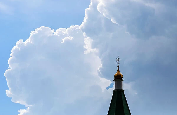 The steeple of Paraskeva Pyatnitsa Chapel is silhouetted against the backdrop of heavy
