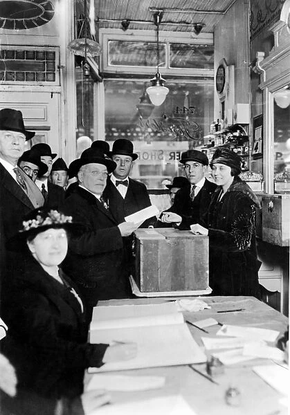 SAMUEL GOMPERS (1850-1924). American labor leader. Gompers voting in an election, c1920