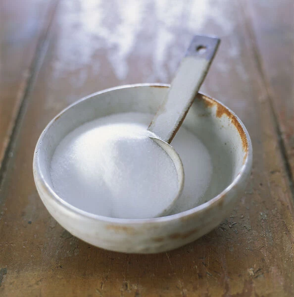 Bowl of sugar with embedded scoop