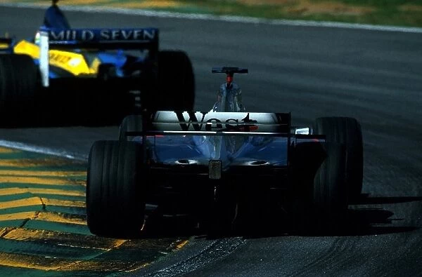 Formula One World Championship: A McLaren Mercedes MP4-17 chases a Renault around the Interlagos circuit