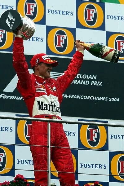 Formula One World Championship: Second placed Michael Schumacher Ferrari celebrates his seventh World Championship on the podium