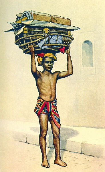 An Indian porter carrying a large basket of luggage on his head, India, from a contemporary print, c. 1935; Artwork