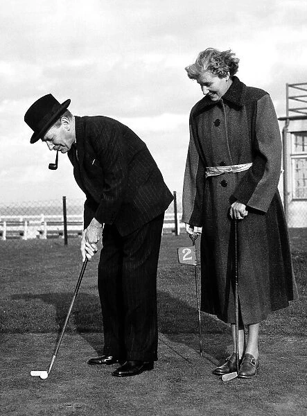 Clement Attlee MP Prime Minister on a putting green with his wife