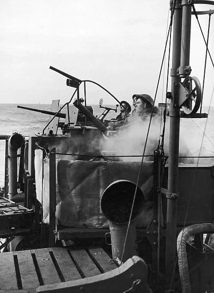 Crew of a Royal Navy minesweeper seen here at action stations during coastal convoy duty