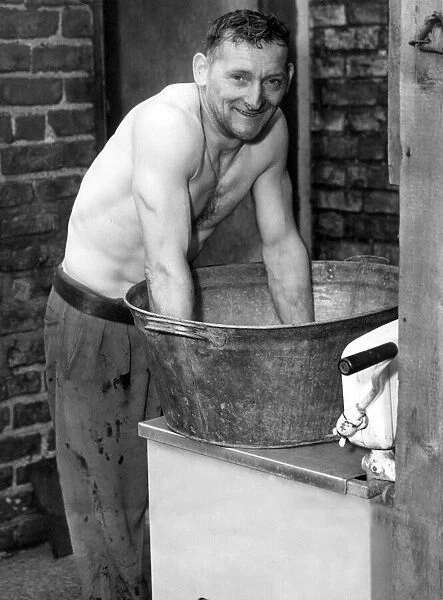 Edward Robson washing in an old tin bath. This will probably be the ast time he will use