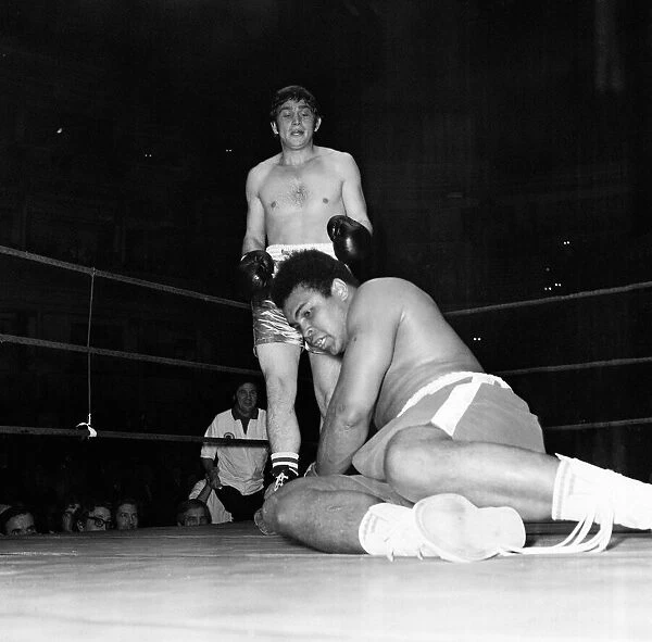 Muhammad Ali falls during his exhibition bout with Johnny Frankam at the Royal Albert