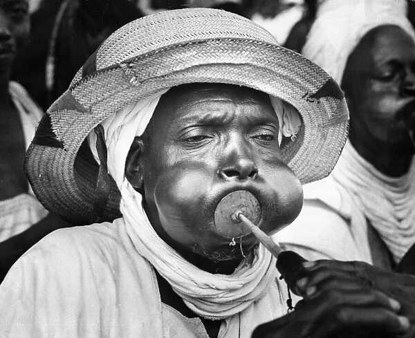A tribesman from Bida in Northern Nigeria blowing his trumpet as part of the reception