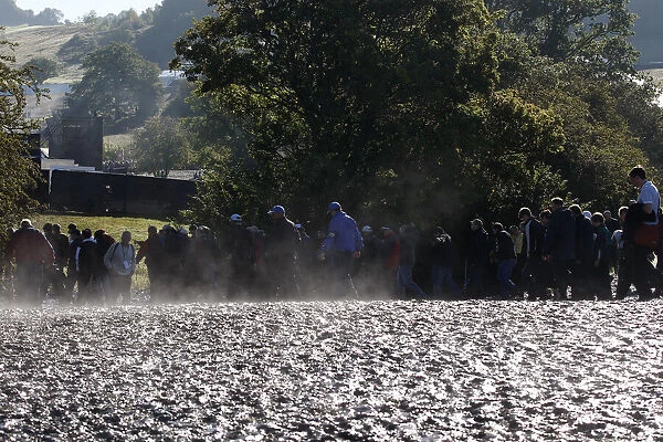 Spectators Walk Through Mud