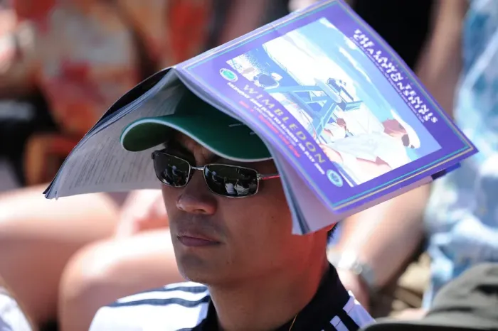 Framed Print : Tennis Fan Keeps Sun Off Head With Programme Framed Print : Tennis Fan Keeps Sun Off Head With Programme