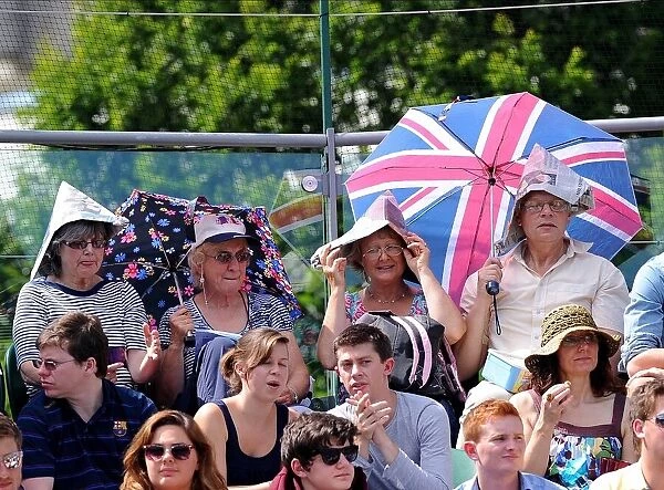 Wimbledon Fans In Paper Hats & Umbrellas