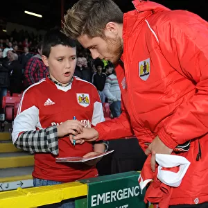 Bristol City's Wes Burns Signs Autograph for Fan at Ashton Gate