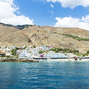 Seaside town resort of Hora Sfakion view from boat trip in the blue sea, Crete island, Greek Islands, Greece, Europe