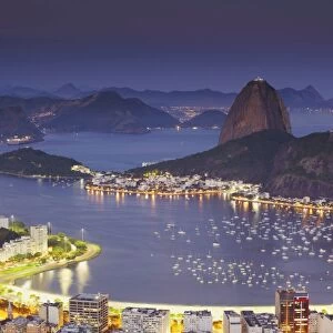 View of Sugar Loaf Mountain (Pao de Acucar) and Botafogo Bay at dusk, Rio de Janeiro, Brazil, South America