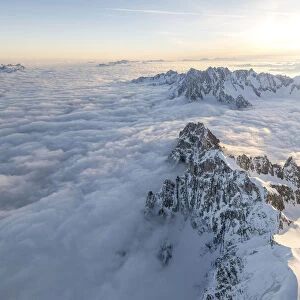 Aerial view of snowy peaks of Mont Blanc during sunrise, Courmayeur, Aosta Valley, Italy