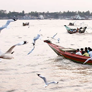 Long boats crossing Irrawaddy River during rush hour, Yangon, Burma (Myanmar)