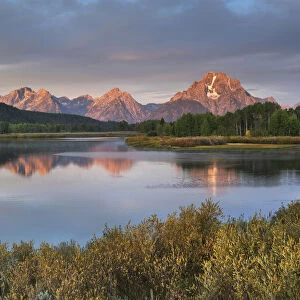 Mount Moran reflected in still waters of the Snake River at Oxbow Bend at sunrise, Grand Teton National Park, Wyoming