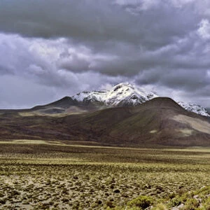 Thunderstorm clouds over the vulcano Isluga, part of Isluga National Park in the Altiplano of Chile