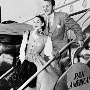 RICHARD CARLSON (1912-1977). American actor, director and screenwriter. Photographed with his wife, Mona, at an airport, 1951