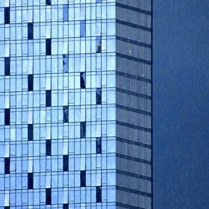 A modern corporate building set against a blue sky at dusk