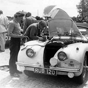 Munich: British driver Ian Appleyard services his Jaguar car at the Munich check
