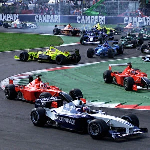 Monza, Italy. 16th Spetember 2001: Juan Pablo Montoya, BMW Williams FW23, leads at the start of the race, as Jenson Button, Benetton Renault B201
