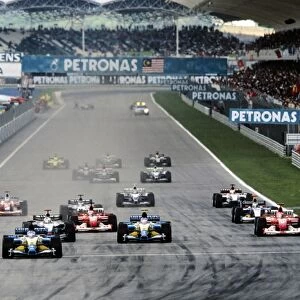 Sepang, Malaysia. 21st - 23rd March 2003: Fernando Alonso, Renault R23, leads at the start of the race