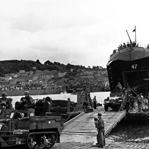 American half track armoured cars disembarking from LST (Landing ship tank