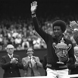 Arthur Ashe waves to fans after winning mens title in 1975 at Wimbledon with Duke of Kent