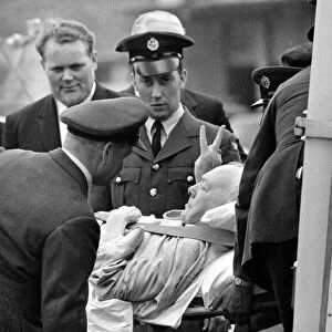 British Prime Minister is stretchered away by medics, as he enters the ambulance