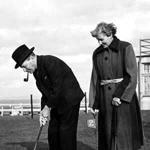 Clement Attlee MP Prime Minister on a putting green with his wife