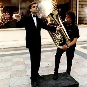 Fireworks director Wilf Scott plays a tuba in front of orchestra conductor Christopher