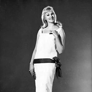 Reveille Fashions 1964: Jo Waring modeling a summer dress with belted detail