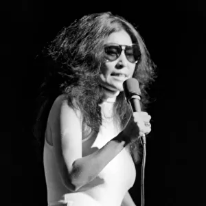 Yoko Ono singing in a charity concert in New York with her husband John Lennon
