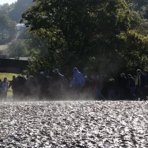 Spectators Walk Through Mud Spectators Walk Through Mud