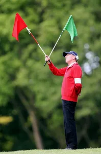Flags Prints: Golf Marshall With Flags