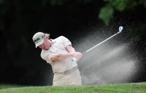 16th Prints: Miguel Angel Jimenez Hits Out Of Bunker On 16th