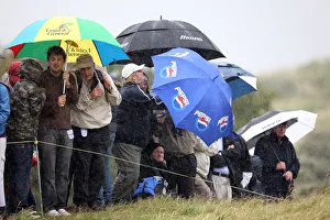 Rain Prints: Spectators Cower In Driving Rain