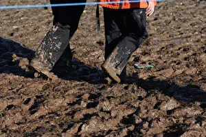 Wade Prints: Spectators Wade Through Mud
