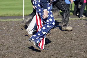 Spectators Wade Through Mud