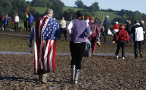 Spectators Walk Through Mud