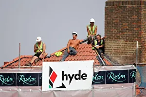 Workers On Roof Top
